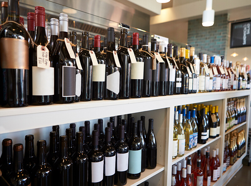 Bottles Of Wine On Display In Delicatessen
